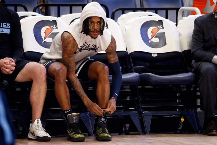 Grizzlies guard Ja Morant ties his shoes during warmups.
